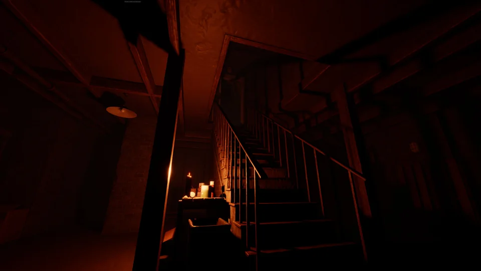 Candlelight glows at the foot of a dark cellar stairway.